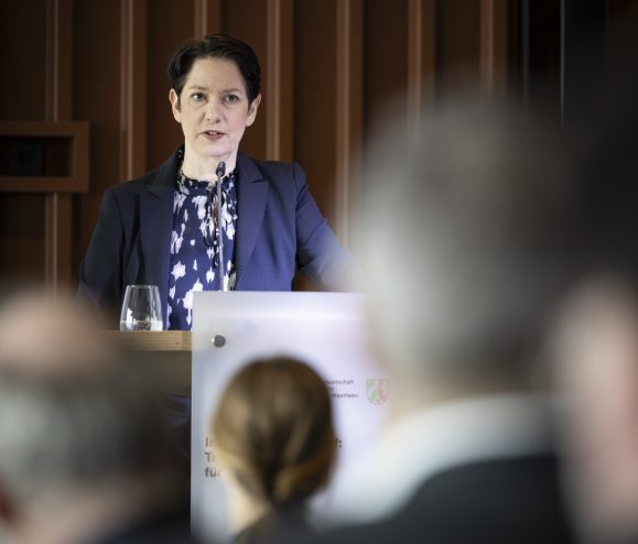 Die Ministerin spricht an einem Pult.